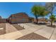 Side view of a single-story home with a two-car garage, tile roof, and a driveway; desert landscaping in front at 16219 W Yucatan Dr, Surprise, AZ 85379