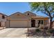 Charming single-story home featuring a two-car garage, tile roof, and a well-manicured front yard with desert landscaping at 16219 W Yucatan Dr, Surprise, AZ 85379