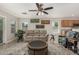 Bright living room with tile floors, a ceiling fan, a beige sofa, and windows for natural light at 16219 W Yucatan Dr, Surprise, AZ 85379