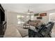 Comfortable living room with neutral decor, a ceiling fan, sliding glass doors, and views of the backyard pool at 16219 W Yucatan Dr, Surprise, AZ 85379