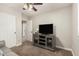 Living room featuring a ceiling fan, television, and carpet at 16219 W Yucatan Dr, Surprise, AZ 85379