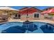 Refreshing pool view showcasing a backyard oasis with comfortable lounge chairs and shaded seating area at 16219 W Yucatan Dr, Surprise, AZ 85379