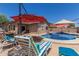 Inviting pool area with comfortable seating and shade offers a relaxing outdoor living space at 16219 W Yucatan Dr, Surprise, AZ 85379