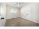 A bright bedroom showcasing hardwood floors, a window, and a closet at 1628 E Sunland Ave, Phoenix, AZ 85040