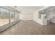 Expansive living area with wood-look floors, large windows, and open access to the kitchen at 1628 E Sunland Ave, Phoenix, AZ 85040