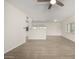 Open-concept living space with wood-look floors and natural light, seamlessly connected to the kitchen at 1628 E Sunland Ave, Phoenix, AZ 85040