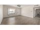 Spacious living area featuring wood-look floors, a ceiling fan, and ample natural light at 1628 E Sunland Ave, Phoenix, AZ 85040