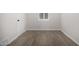 An empty room featuring hardwood floors and neutral walls provides a blank canvas at 1628 E Sunland Ave, Phoenix, AZ 85040