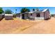 View of the home's backyard with a patio and gravel landscaping at 1733 W Surrey Ave, Phoenix, AZ 85029