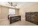 This bedroom features wood floors, a ceiling fan, natural light, a bed and a chest of drawers at 1733 W Surrey Ave, Phoenix, AZ 85029
