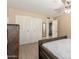Bedroom boasts wood floors, spacious closet, a ceiling fan, natural light, and an en-suite bathroom at 1733 W Surrey Ave, Phoenix, AZ 85029