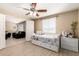 Inviting bedroom with wood floors, a ceiling fan, lots of natural light, and a built-in day bed at 1733 W Surrey Ave, Phoenix, AZ 85029