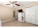 Bedroom with wood floors, closet, ceiling fan, blinds and a storage cabinet with a TV at 1733 W Surrey Ave, Phoenix, AZ 85029