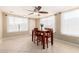 Bright dining area features a ceiling fan, light walls, tile floors, and a wooden table with four chairs at 1733 W Surrey Ave, Phoenix, AZ 85029