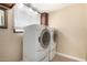 This laundry room has modern washer and dryer, window, and natural light at 1733 W Surrey Ave, Phoenix, AZ 85029
