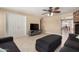 Open-concept living area with tile floors, a ceiling fan, and easy access to the dining area at 1733 W Surrey Ave, Phoenix, AZ 85029