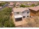 Aerial view showcasing a home with desert landscaping and backyard patio in a neighborhood at 17433 W Holland Ln, Surprise, AZ 85388