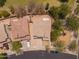 An aerial view of a well-maintained property surrounded by green trees and a nearby playground in a desirable neighborhood at 17433 W Holland Ln, Surprise, AZ 85388