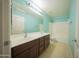 Bathroom featuring a double sink vanity, tub, and a shower with natural light gives it a clean, refreshing feel at 17433 W Holland Ln, Surprise, AZ 85388