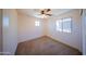 Bedroom features neutral carpet, ceiling fan, and two windows for natural light creates a warm space at 17433 W Holland Ln, Surprise, AZ 85388