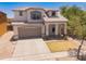 Attractive two-story house with a well-maintained lawn and attached garage at 17433 W Holland Ln, Surprise, AZ 85388