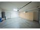 Spacious garage with built-in shelving and an open area for parking at 17433 W Holland Ln, Surprise, AZ 85388