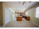 Well-lit kitchen featuring wooden cabinets, black appliances, and tile flooring at 17433 W Holland Ln, Surprise, AZ 85388