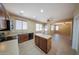Bright eat-in kitchen features an island and access to a living space with plenty of natural light at 17433 W Holland Ln, Surprise, AZ 85388