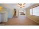 Open-concept living space with tile floors, a staircase, and a glimpse into the kitchen at 17433 W Holland Ln, Surprise, AZ 85388