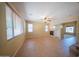 Cozy living room showcasing tile flooring, a fireplace, and large windows with natural light at 17433 W Holland Ln, Surprise, AZ 85388