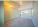 Spacious living room with tile flooring, high ceilings, carpet, and staircase to the second floor at 17433 W Holland Ln, Surprise, AZ 85388