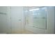 Shower and bathtub with a glass screen and a small window providing natural light at 17433 W Holland Ln, Surprise, AZ 85388