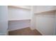 Walk-in closet with carpet and wooden racks for storage at 17433 W Holland Ln, Surprise, AZ 85388