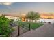 Well-maintained backyard with lush turf, desert landscaping, and a charming covered patio at 17706 N Rosa Dr, Maricopa, AZ 85138