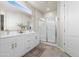 Bright bathroom featuring a double vanity, sleek fixtures, and a frameless glass shower enclosure at 17706 N Rosa Dr, Maricopa, AZ 85138