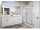Bright bathroom featuring a double vanity with modern finishes and a glass-enclosed shower at 17706 N Rosa Dr, Maricopa, AZ 85138