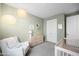 Serene Bedroom with soft lighting, a rocking chair, and subtle decor accents on the pastel green walls at 17706 N Rosa Dr, Maricopa, AZ 85138