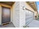 A detailed view of the front entrance, highlighting the stone accents, modern garage door, and inviting entry of the home at 17706 N Rosa Dr, Maricopa, AZ 85138