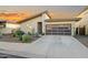 Charming single-story home with desert landscaping, modern garage door, and neutral color palette at 17706 N Rosa Dr, Maricopa, AZ 85138