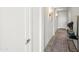 Bright hallway featuring sconce lighting, a console table, and clean, modern design at 17706 N Rosa Dr, Maricopa, AZ 85138