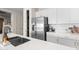 Modern kitchen design with a large island, stainless steel refrigerator, and white cabinetry, offering ample counter space at 17706 N Rosa Dr, Maricopa, AZ 85138