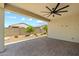 The back patio has pavers and a ceiling fan for enjoying the outdoors at 18032 W Muirwood Dr, Goodyear, AZ 85338