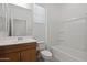 Clean bathroom featuring a wood vanity, a mirror, and a combined tub and shower at 18032 W Muirwood Dr, Goodyear, AZ 85338