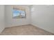 Well-lit bedroom with a large window offering views of the neighborhood at 18032 W Muirwood Dr, Goodyear, AZ 85338
