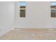 Bright bedroom with tile flooring and natural light from two windows at 18032 W Muirwood Dr, Goodyear, AZ 85338