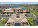 Community clubhouse boasts a lake and mountains in the distance for scenic backdrop at 18032 W Muirwood Dr, Goodyear, AZ 85338
