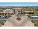 Aerial view of a clubhouse facility that includes a lake and lush desert landscaping at 18032 W Muirwood Dr, Goodyear, AZ 85338