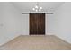 Dining area showcases sliding barn doors and tile flooring at 18032 W Muirwood Dr, Goodyear, AZ 85338