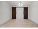 Dining area features sliding barn doors for privacy and tile flooring at 18032 W Muirwood Dr, Goodyear, AZ 85338