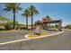 View of the entrance to the community with palm trees and attractive signage and archway at 18032 W Muirwood Dr, Goodyear, AZ 85338